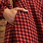 Close-up of side pocket on red, black, and cream plaid dress
