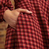 Close-up of side pocket on red, black, and cream plaid dress