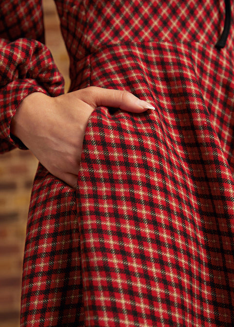 Close-up of side pocket on red, black, and cream plaid dress