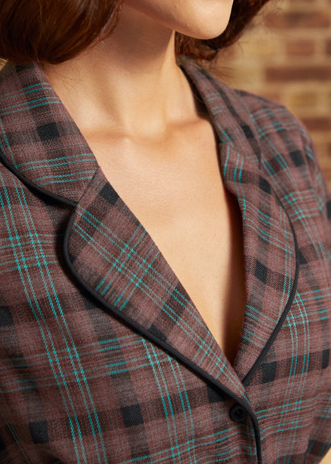 Close-up of the notched lapel collar with black piping and brown plaid fabric featuring black checks and fine turquoise stripes.