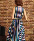 Back view of the striped fit-and-flare dress showing the sleeveless bodice, center back zipper, defined waistband, and flared skirt with vertical stripes.