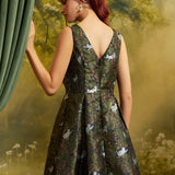 Rear three-quarter view of a ModCloth cat print dress showing the V-back, smocked side panel, fitted waist, and flared skirt.