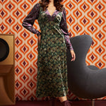 Woman wearing green and burgundy mixed paisley midi dress with burgundy lace-up boots, full front view