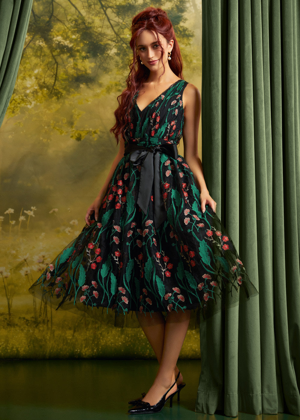 Woman wearing the ModCloth Memory Lane Fit and Flare party dress in Enchanted Meadow floral embroidery on black tulle