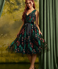 Woman wearing the ModCloth Memory Lane Fit and Flare party dress in Enchanted Meadow floral embroidery on black tulle