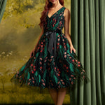 Woman wearing the ModCloth Memory Lane Fit and Flare party dress in Enchanted Meadow floral embroidery on black tulle