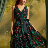 Front view of the Memory Lane Fit & Flare Dress featuring coral floral embroidery and green botanical vines on black mesh, a V-neckline, and a black ribbon waist bow.