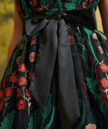 Close-up of the black satin-look waist sash tied into a bow over the embroidered floral mesh of the Memory Lane Fit & Flare Dress.