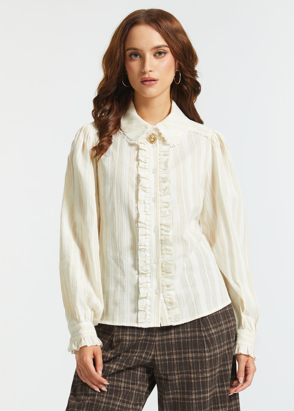 Front view of an ivory long-sleeve blouse with a lace collar, ruffled button front, subtle vertical stripes, and puff sleeves.