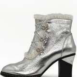 Silver metallic ankle boot with lace-up design on a white background