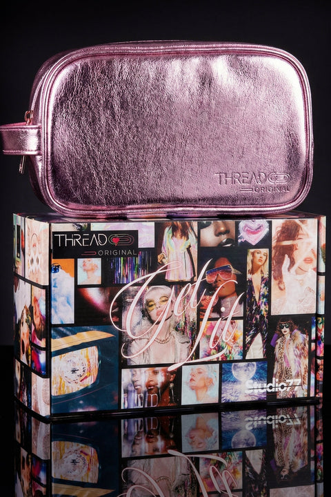 Pink makeup pouch on top of a colorful box with 'Get Lit' branding