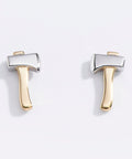 Pair of gold and silver axe-shaped earrings on a light gray background