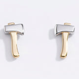 Pair of gold and silver axe-shaped earrings on a light gray background