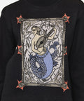 Black sweater with a mermaid graphic design on a plain background