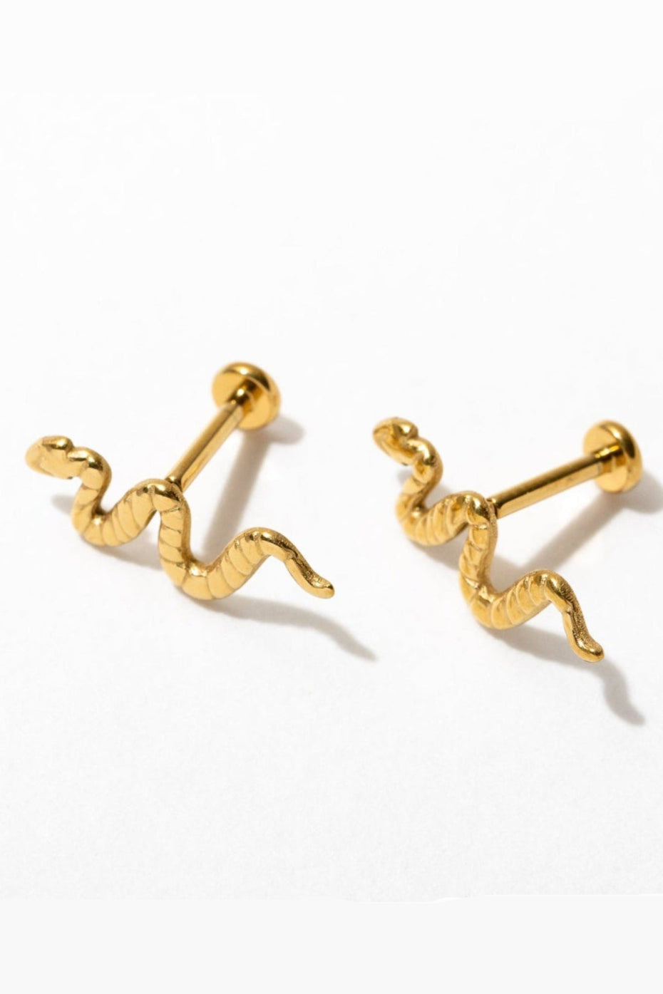 Pair of gold snake-shaped earrings on a white background