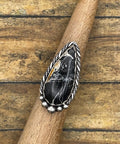 Artisan made sterling silver ring with teardrop shaped White Buffalo Turquoise gemstone