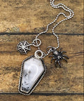 Artisan made sterling silver necklace with a coffin shaped pendant featuring a spider and web charms