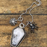 Artisan made sterling silver necklace with a coffin shaped pendant featuring a spider and web charms