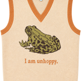 A cream-colored knit sweater vest with orange trim, featuring a knitted green and brown frog graphic and the text 'I am unhoppy.' on the front.