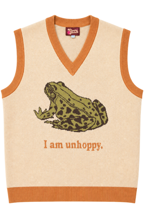 A cream-colored knit sweater vest with orange trim, featuring a knitted green and brown frog graphic and the text 'I am unhoppy.' on the front.