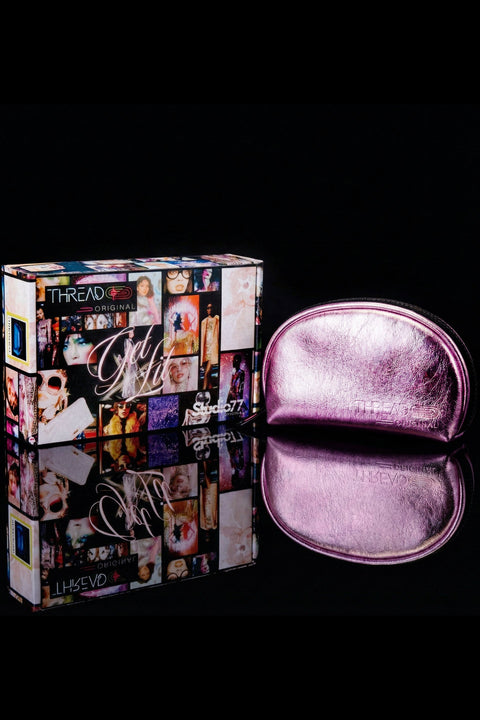 Pink makeup case with 'Thread Original' branding next to a colorful box on a black background