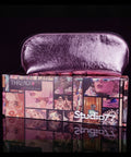 Pink makeup pouch on top of a box with 'Thread Original' branding, against a black background