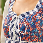 Close-up of a floral and checkered dress with a blurred background