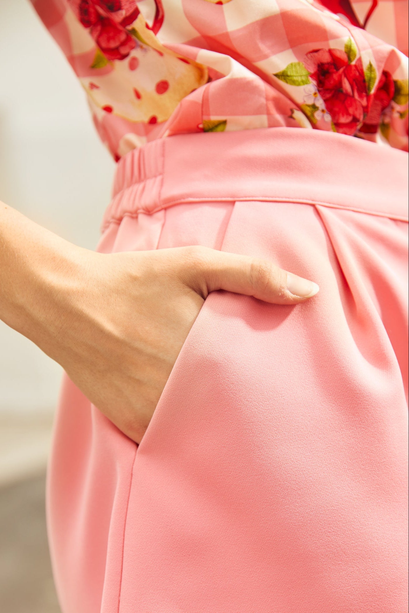 Close-up of a woman wearing pink shorts with pockets