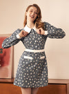 Woman in patterned dress with peter pan collar