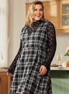 Woman in large plaid navy and red print dress