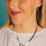 Woman wearing a silver necklacebackground
