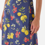Navy blue skirt with colorful fruit pattern worn by a woman