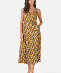 Woman wearing a patterned dress on a white background