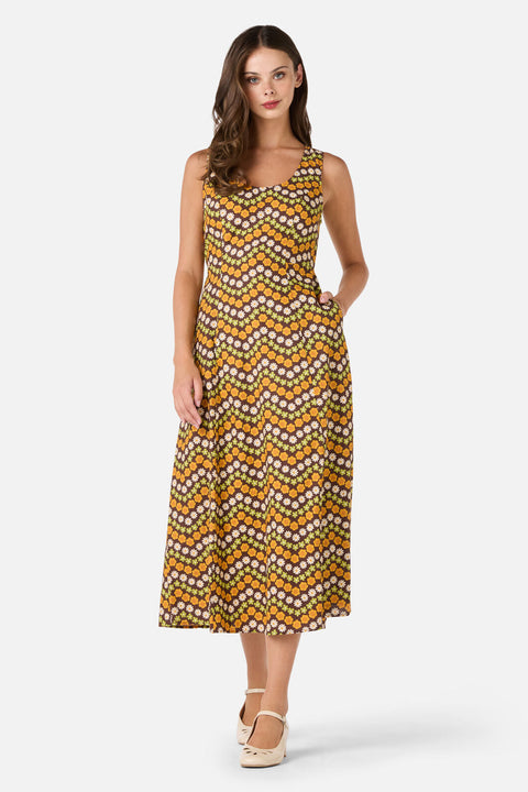 Woman wearing a patterned dress on a white background
