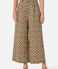 Person wearing a patterned wide-leg pants on a white background