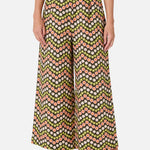 Person wearing a patterned wide-leg pants on a white background
