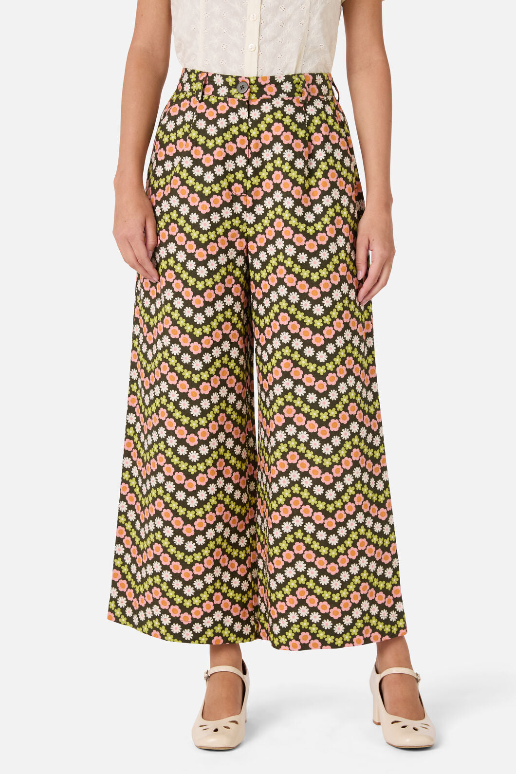 Person wearing a patterned wide-leg pants on a white background