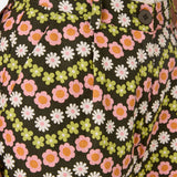 Floral patterned pants with a button detail on a dark background