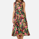 Woman wearing a colorful floral dress on a white background