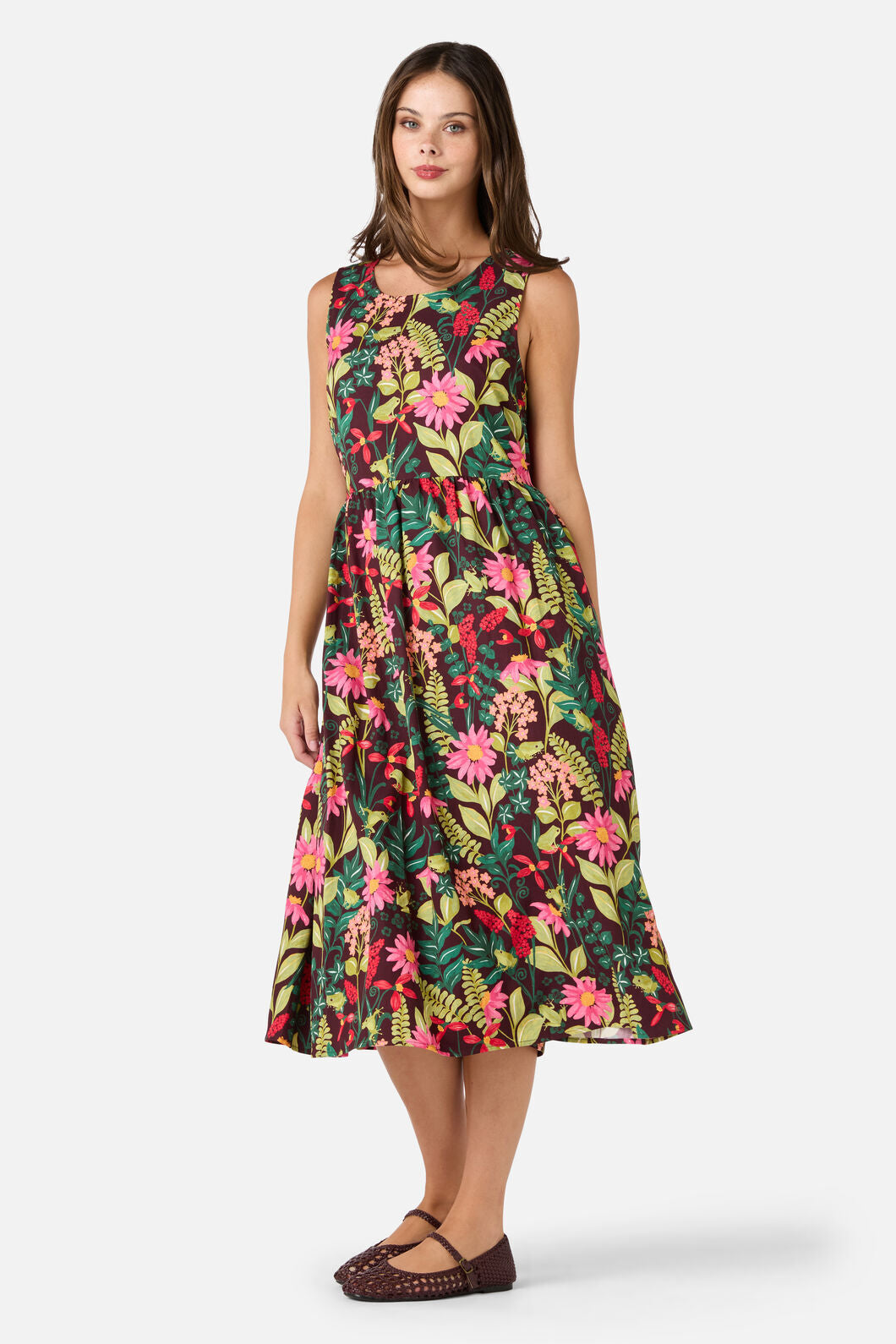 Woman wearing a colorful floral dress on a white background