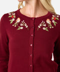 Red cardigan with bird and floral embroidery on a white background