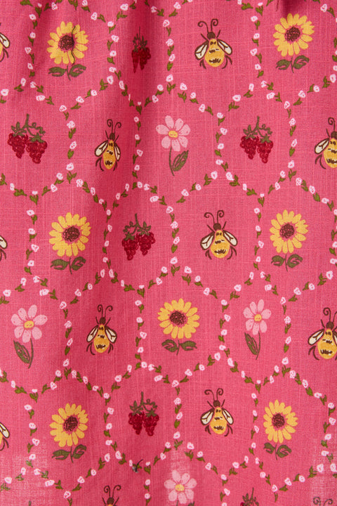 Pink fabric with bee and flower pattern