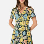 Woman wearing a floral dress with a white background