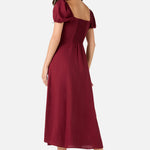 Woman wearing a burgundy dress on a white background