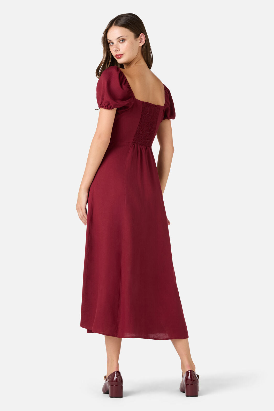 Woman wearing a burgundy dress on a white background