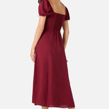 Woman wearing a burgundy dress on a white background
