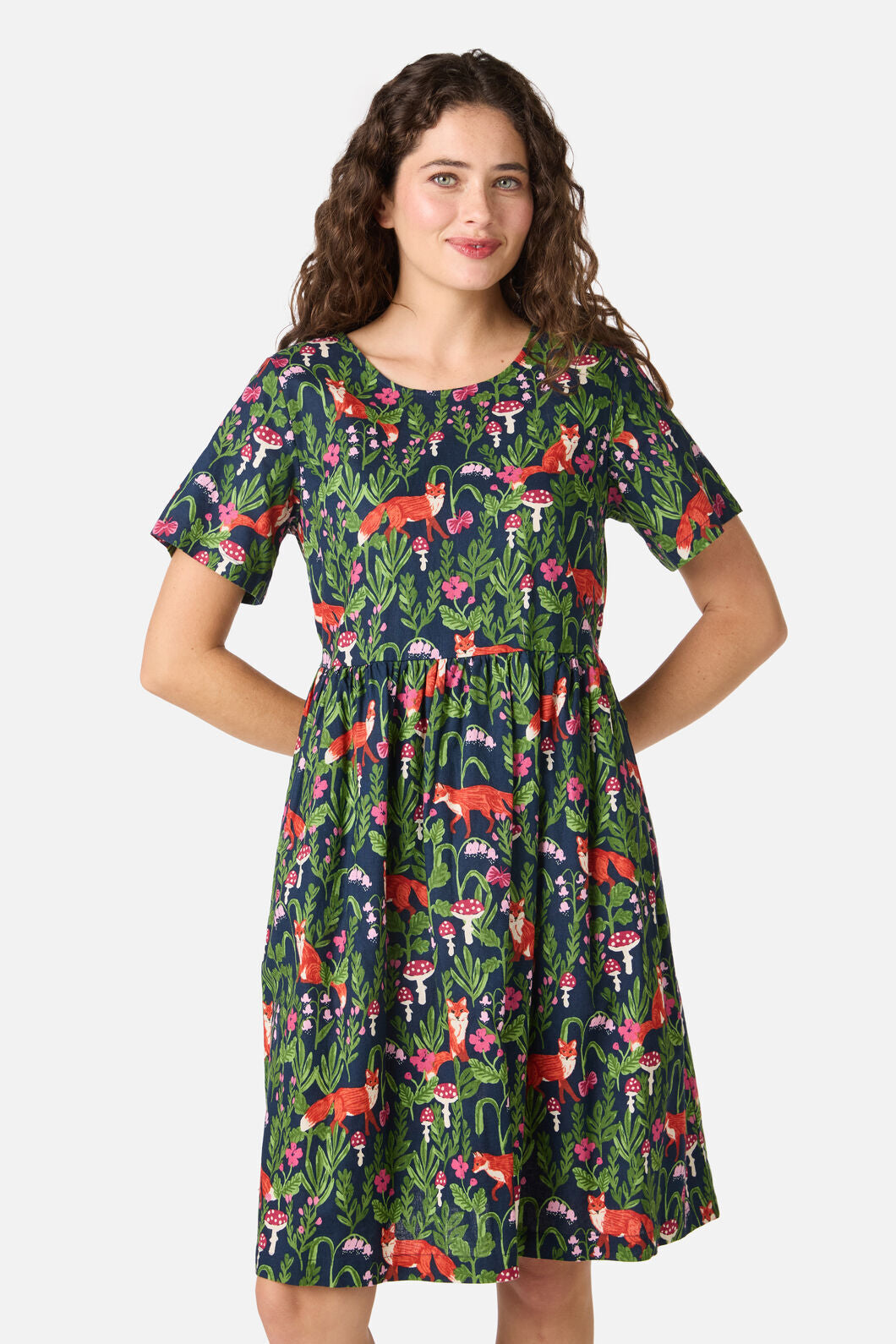 Woman wearing a colorful dress with fox pattern on a white background