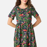Woman wearing a colorful dress with fox pattern on a white background