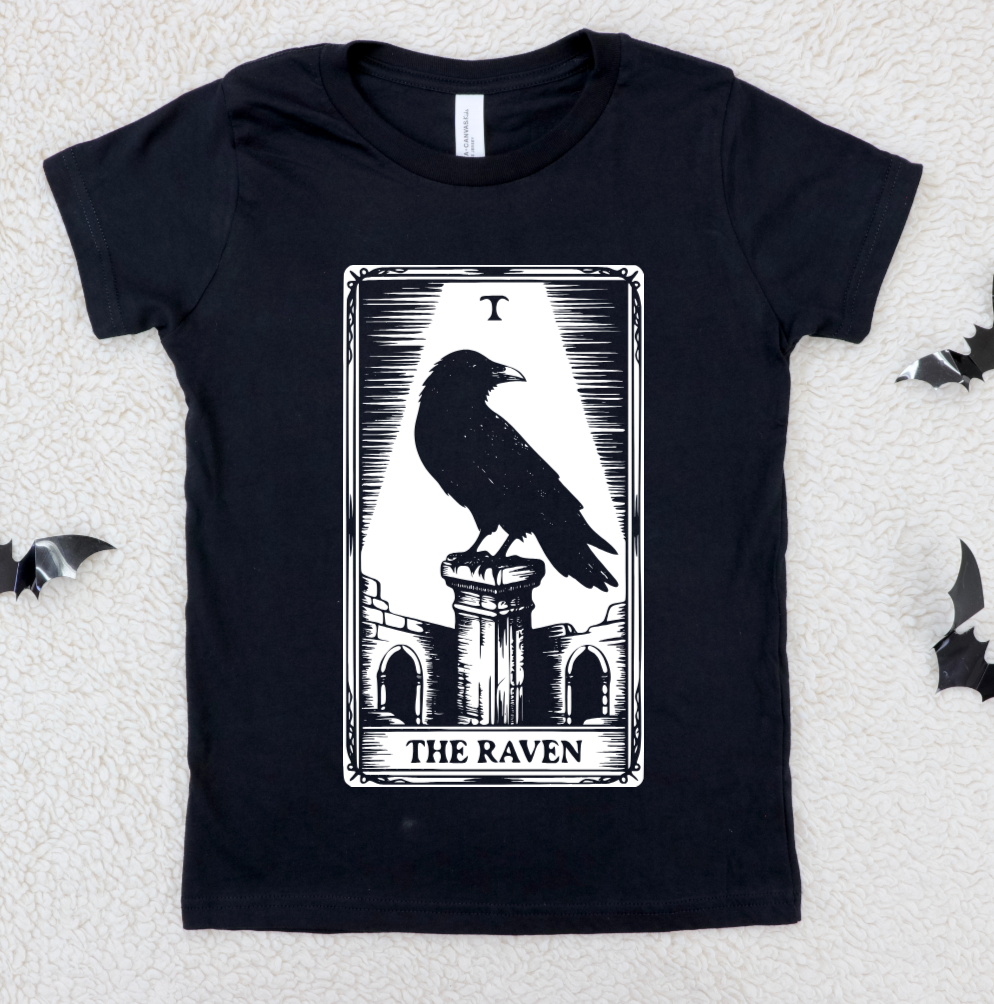 Black t-shirt with 'The Raven' tarot card design on a textured white background