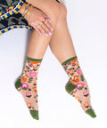 Person wearing floral-patterned socks with a white background